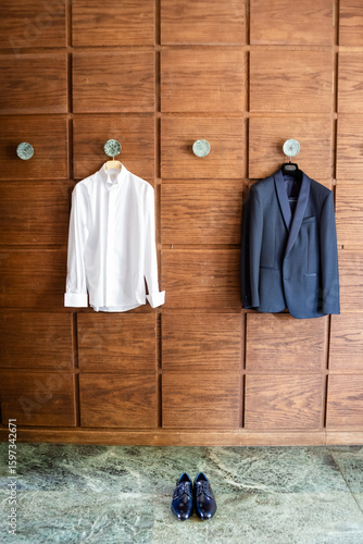 Wedding attire preparation in elegant venue with wooden backdrop