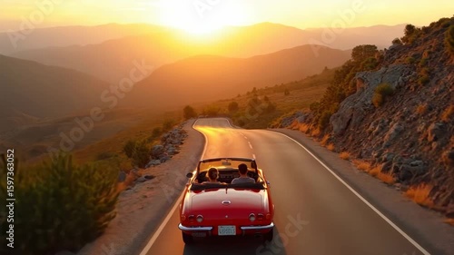 Amazing epic inspiring travel drone aerial shot following red convertible car with friends on empty mountain scenic road driving into sunset, concept tourism destination and summer.