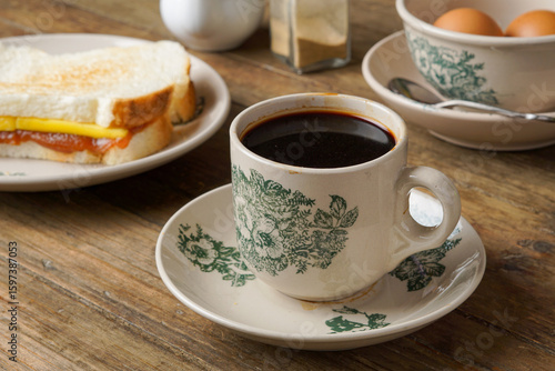Traditional Black Coffee in Classic Kopitiam Cup on Table for Vintage Malaysian Breakfast Concept