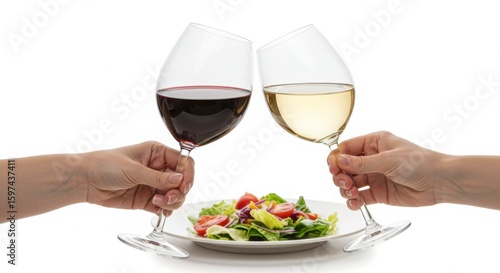 Two hands holding wine glasses toasting over salad