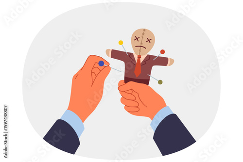 Voodoo doll in hands of business man who uses black magic and pagan curses for unfair competition. Vindictive guy pierces voodoo doll with needles, wanting to make enemy or competitor suffer
