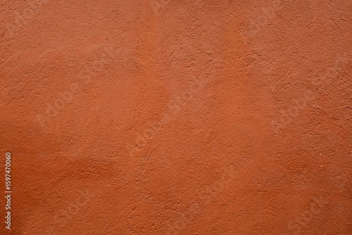 Russet-toned textured surface, possibly leather or plaster.