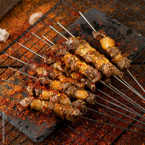 Fotografie Grilled lamb skewers sprinkled with chili powder and skewered with iron sticks