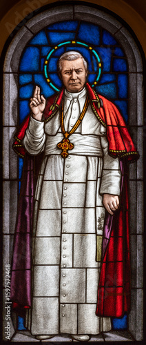 Milan - The St. pope Pius X on the stained glass in the church Chiesa di San Agostino by Eugenio Cisterna from beginn of 20. cent.