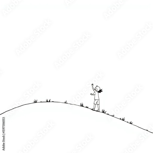 A child releasing a balloon on a windswept hill