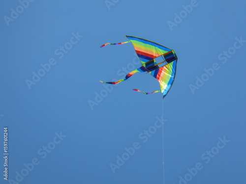 Colorful kite floating on the blue sky