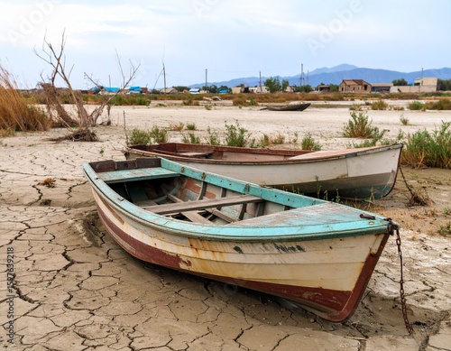 Dried lakebed with abandoned boats in Kazakhstan, environmental disaster