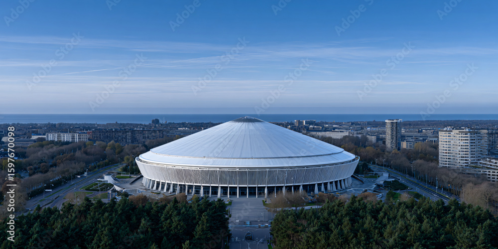 Fototapeta premium Futuristic Johan Cruyff Arena Aerial View Modern Stadium Design Drone Shot of Amsterdam Arena Architectural Marvel Innovative Sports Venue Top Down View of Football Stadium 