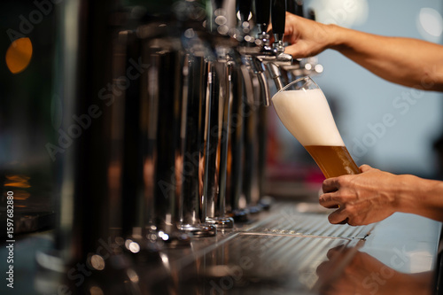 Canvas Print Craft beer is being poured into glasses to be served.