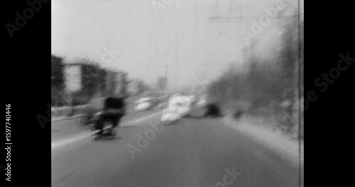 Traffic on a busy city road, traffic from cars, residential buildings and trolleybus wires. Archive video of Minsk in the 1970s, Belarus