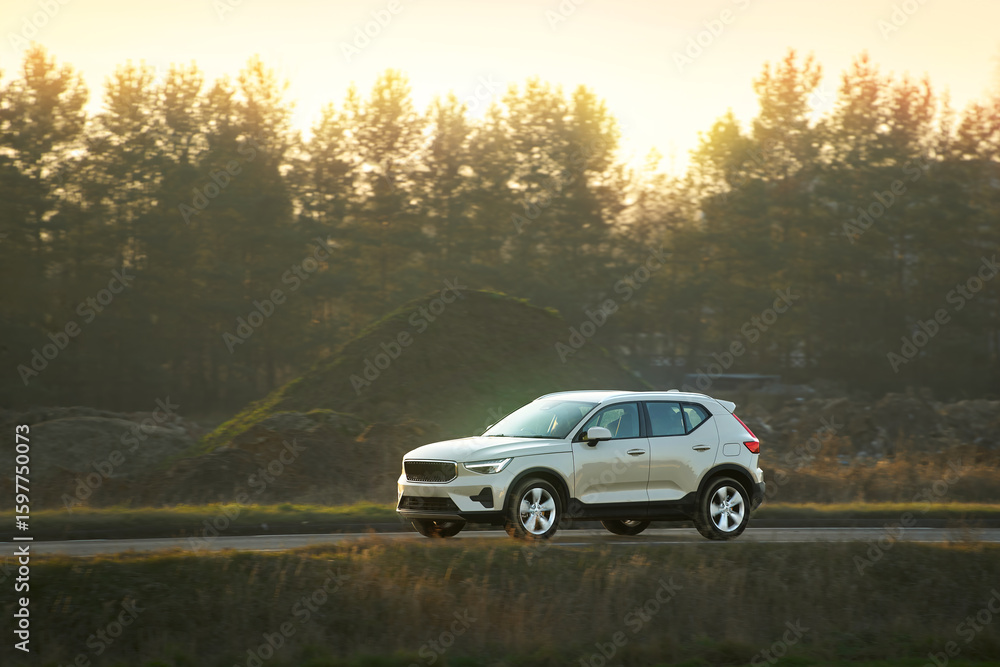 Car on asphalt road surrounded by fall foliage Car on asphalt road surrounded by fall foliage