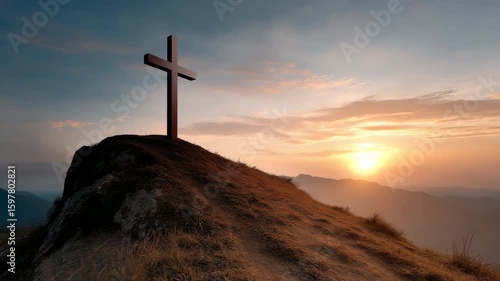 A cross is on top of a hill with a beautiful sunset in the background. Concept of peace and serenity, as the cross stands as a symbol of faith