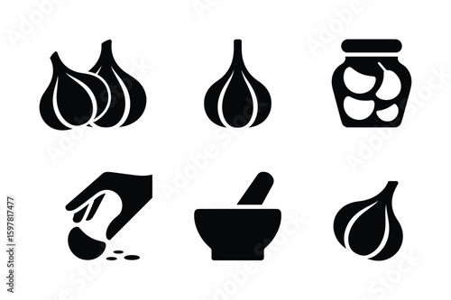 Garlic bulbs jar mortar pestle and hand preparing cloves pickled