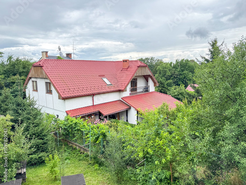 Wallpaper Mural A charming countryside house with a red tiled roof is surrounded by lush greenery Torontodigital.ca