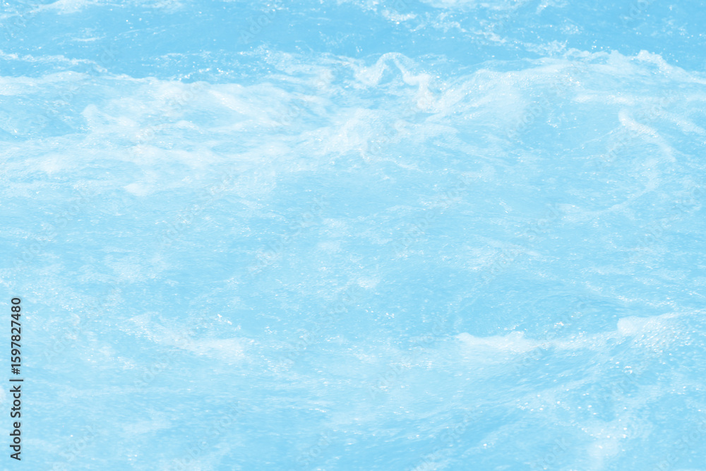 Obraz premium Blue water with ripples on the surface. Defocus blurred transparent blue colored clear calm water surface texture with splashes and bubbles. Water waves with shining pattern texture background.