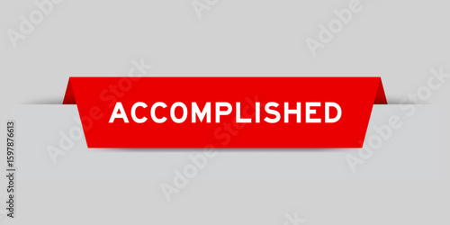 Red color inserted label with word accomplished on gray background