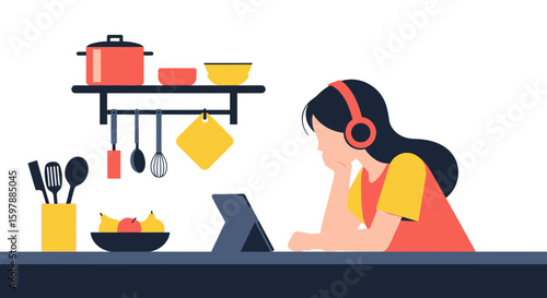 Woman Learning Online Cooking Recipes Using Tablet with Kitchen Utensils