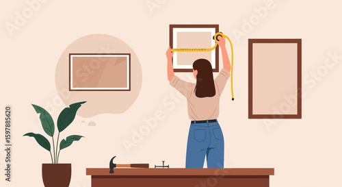 Woman Measuring Picture Frame on Wall for Gallery Wall Project at Home