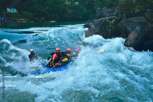 Thrilling river rafting scene in Dandeli, Karnataka, India.  A raft navigates churning rapids, showcasing exciting action and dynamic composition.
