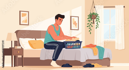 Young Man Folding Clothes At Home In Bedroom During Leisure Time