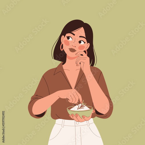 Young woman contemplating a bowl of food, holding it in one hand and touching her chin with the other, looking upwards.