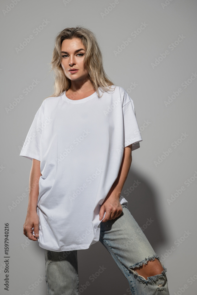 Fototapeta premium Confident Woman Wearing Oversized White T-Shirt with Blank Space for Mockup