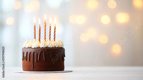 A beautifully decorated chocolate cake with five lit candles, set against a softly blurred background of warm lights, This image is perfect for birthday celebrations, event planning