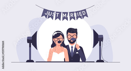 Newlyweds Posing With Accessories Under Just Married Banner In A Photo Booth