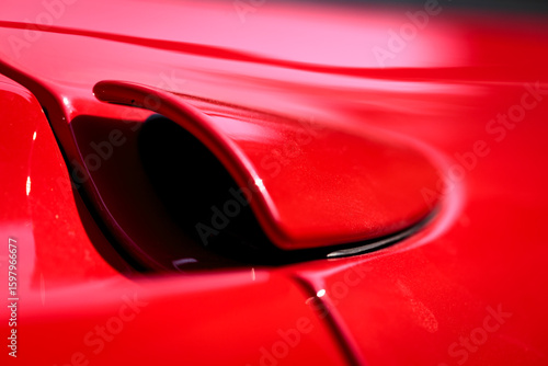 Rear side closeup detail of a famous red Italian supercar. Rosso corsa is the red international motor racing colour of cars entered by teams from Italy