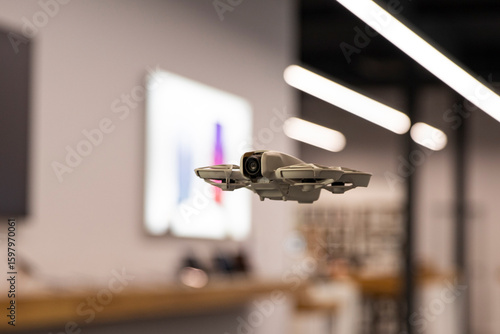 Unmanned aerial vehicle, innovation and aerial photography. Modern drone indoors, technologies of the future