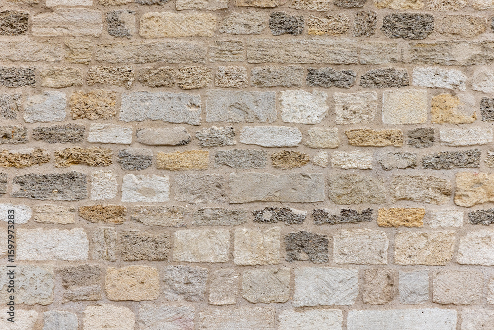 Fototapeta premium Textured Stone Brick Wall for Architectural and Background Design Applications