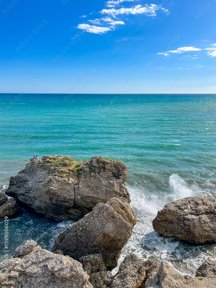 Waves crashing against coastal rocks, splashing water under the bright sun. Vibrant ocean energy, dramatic seascape, nature’s power. Waves crashing against coastal rocks, splashing water under the bright sun. Vibrant ocean energy, dramatic seascape, nature’s power.