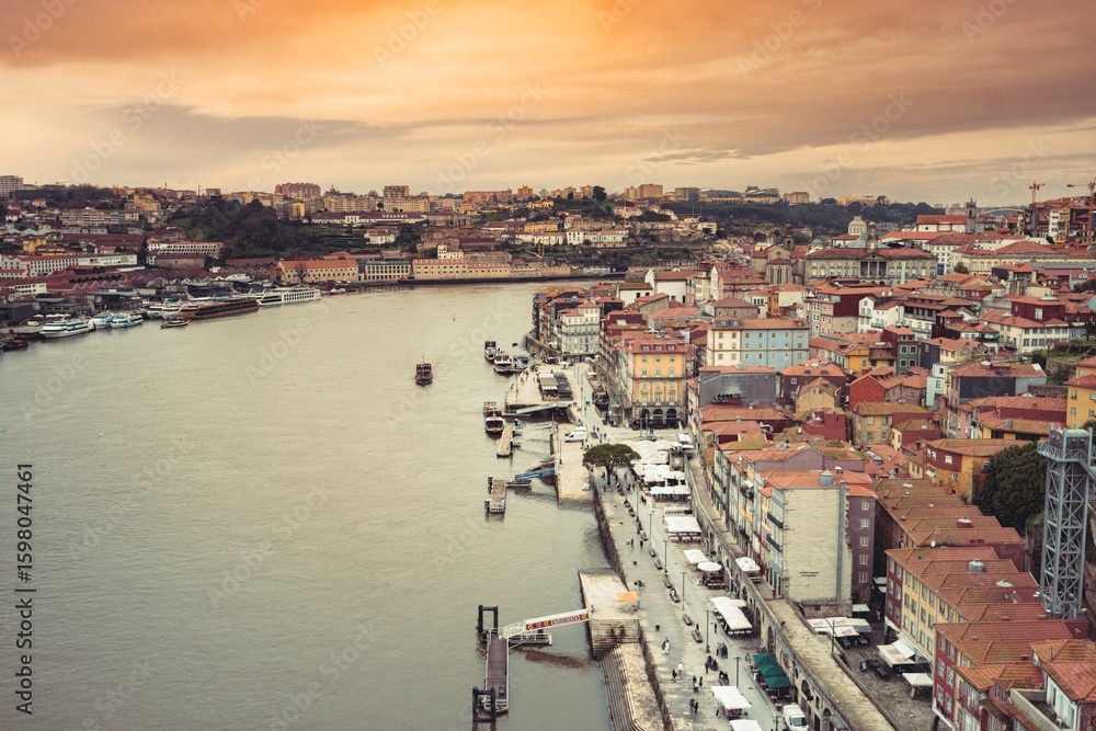 Obraz premium Diverse people explore Vila Nova de Gaia and the Ribeira district from above during the sunset, admiring the colorful houses and Douro river