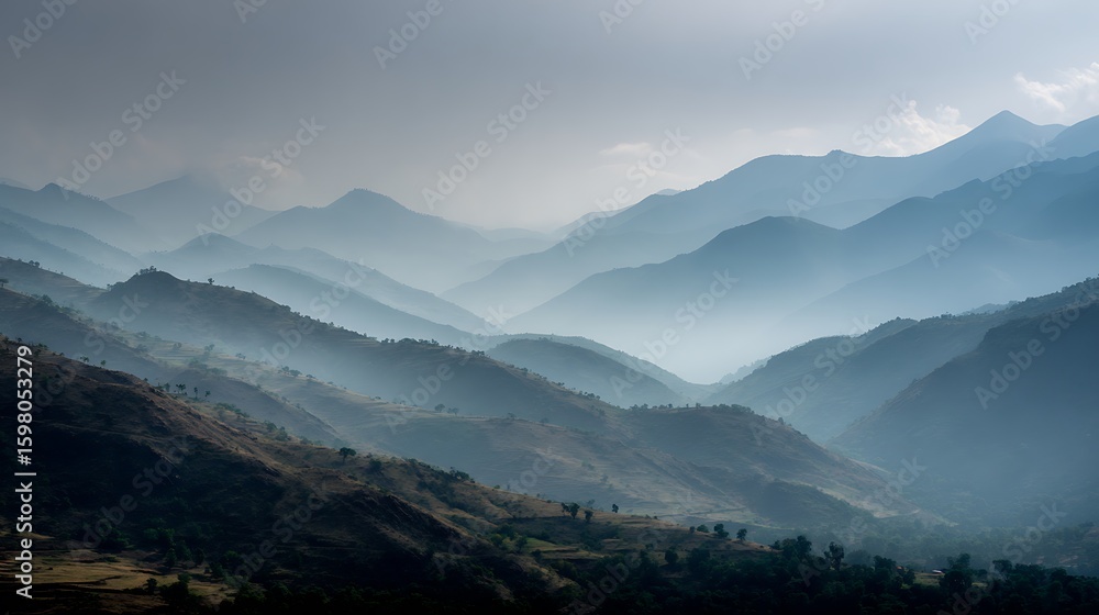 Fototapeta premium Misty mountain landscape with layered ridges fading into the distance