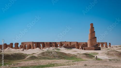 Historical ruins of Abu Dulaf stand against a clear blue sky in Iraq