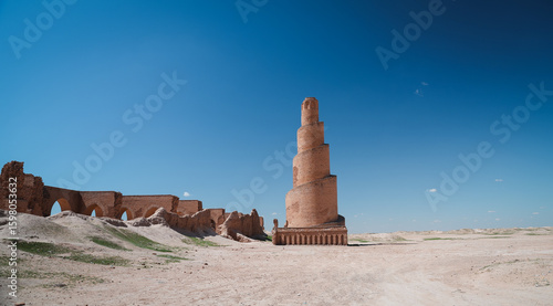 Exploring the ancient minaret and ruins in Abu Dulaf Iraq under a clear sky