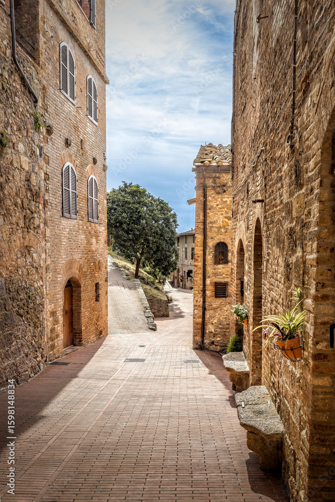 Obraz premium Old mediaval empty street in the historic Tuscan town of San Gimignano, Italy