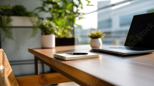 A minimalist modern office desk with natural light and blurred surroundings