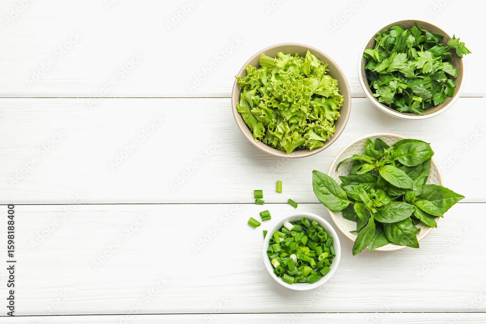 Obraz premium Different aromatic herbs in bowls on white wooden table, flat lay. Space for text