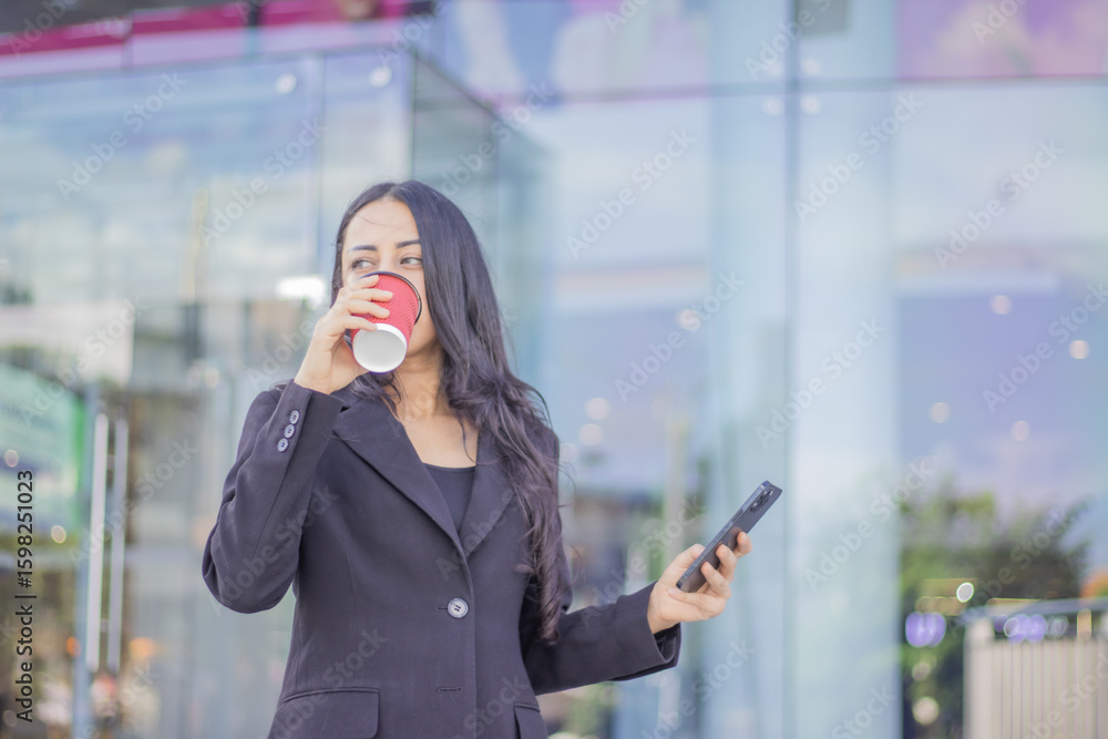 Confident Indian businesswoman in her 40s smiling while talking on her mobile phone and walking in the city. A diverse, professional, connected and modern team environment. Confident Indian businesswoman in her 40s smiling while talking on her mobile phone and walking in the city. A diverse, professional, connected and modern team environment.