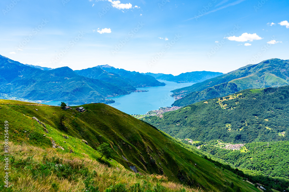 Fototapeta premium Panorama of Lake Como from above, photographed at Alpe Motta, Peglio, with a view of the mountains and lakeside villages.