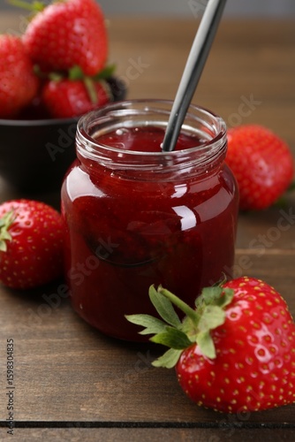 Wallpaper Mural Tasty homemade strawberry jam in glass jar and berries on wooden table, closeup Torontodigital.ca