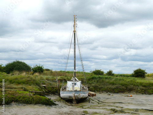 Stranded Sailboat on a Muddy Tideflat

