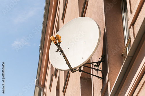 Slika na platnu Satellite TV dish on residential building