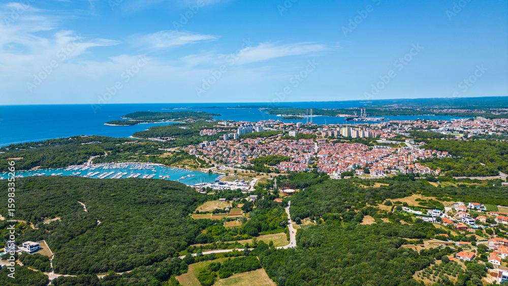 Fototapeta premium Aerial view of Pješčana Uvala near Pula, Croatia – beachside village, marina, turquoise sea and lush green coastline