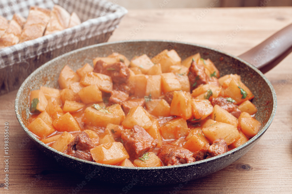 Hearty vegetable stew with meat, in a frying pan, with freshly baked bread, close-up, Hearty vegetable stew with meat, in a frying pan, with freshly baked bread, close-up,