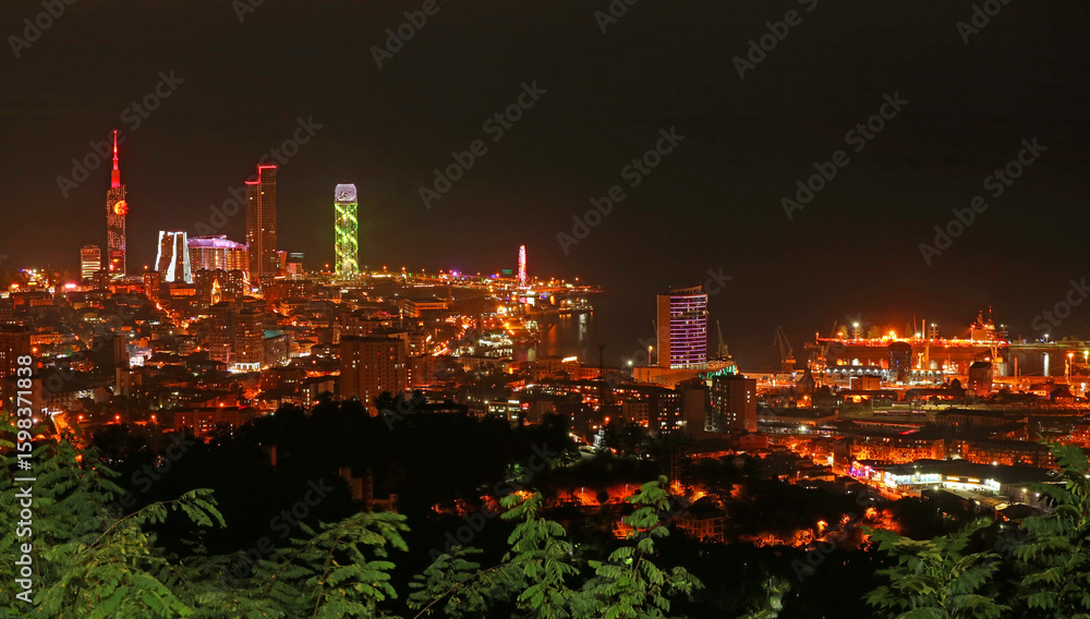Fototapeta premium Stunning lit up cityscape at night of Batumi as seen from Anuria mountain viewing platform, Batumi, Georgia
