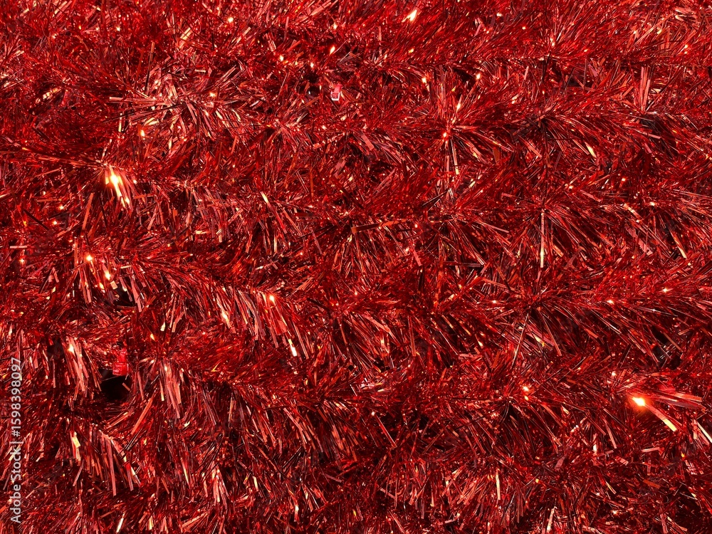 Close-up of vibrant red tinsel with sparkling highlights, evoking a festive and celebratory holiday atmosphere. Ideal for Christmas or party-themed designs. Close-up of vibrant red tinsel with sparkling highlights, evoking a festive and celebratory holiday atmosphere. Ideal for Christmas or party-themed designs.