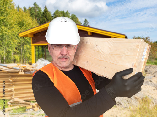 Man builder carries boards....