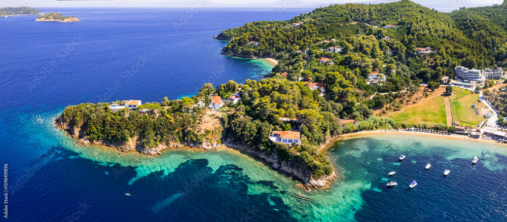 Fototapeta premium Greece. Best beautiful beaches of Skiathos island (Sporades) -Kanapitsa beache popular tourist destination and resorts. High angle drone aerial view